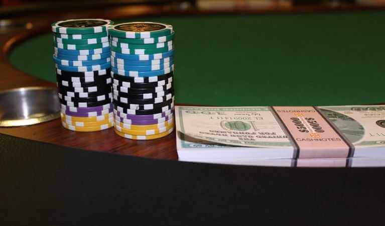 A picture of casino chips and dollar bills