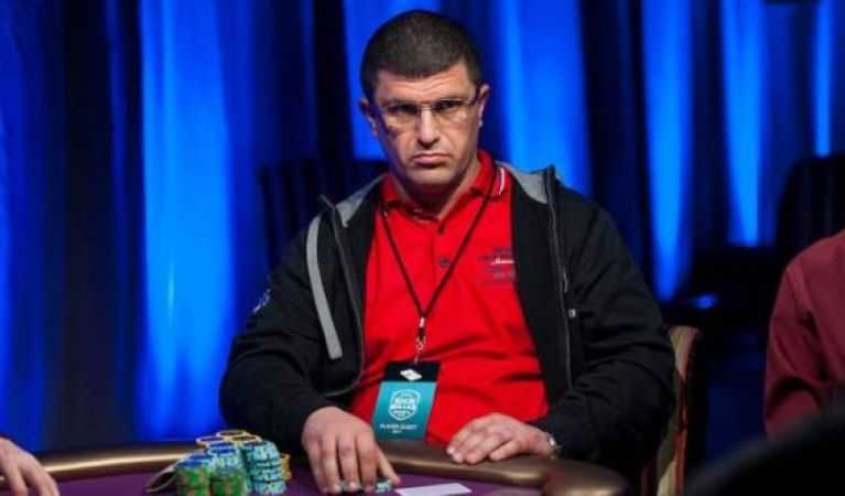 Tsoukernik sitting at a poker table while game is afoot