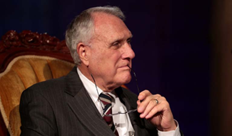 Jon Kyl sitting in a chair.