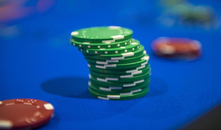 Poker chips on the felt of a poker table.