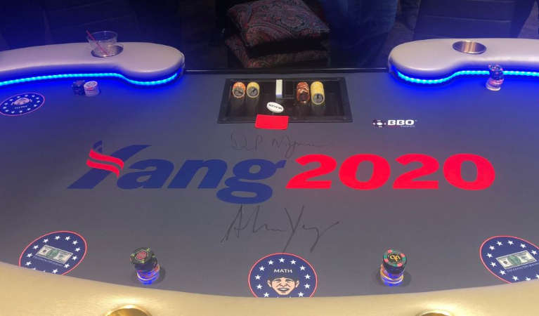 A poker table with Andrew Yang's campaign table