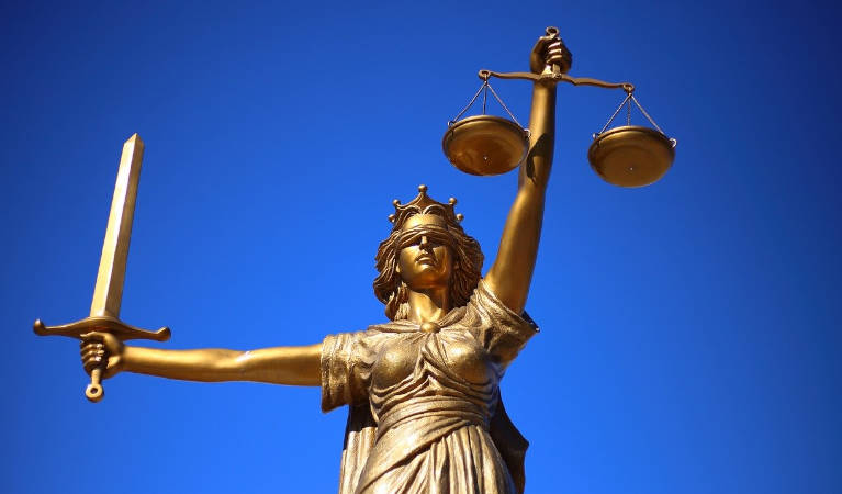 Lady Justice holding the scales blindfolded.