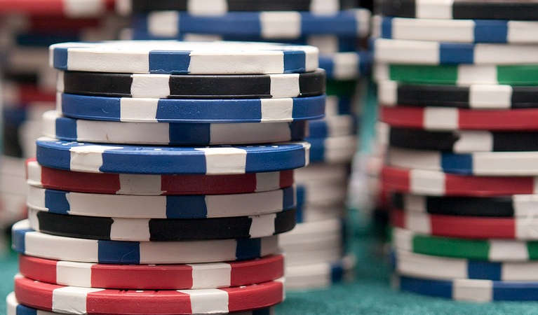 Online poker chips stacked up on a table.