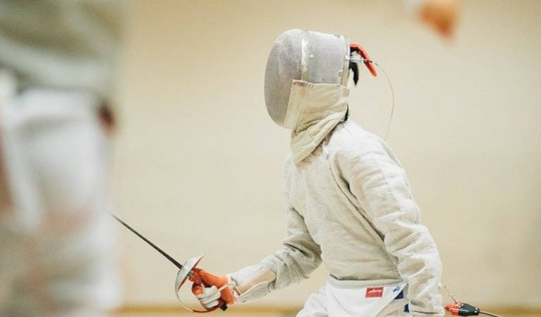 A man holding a sabre fencing