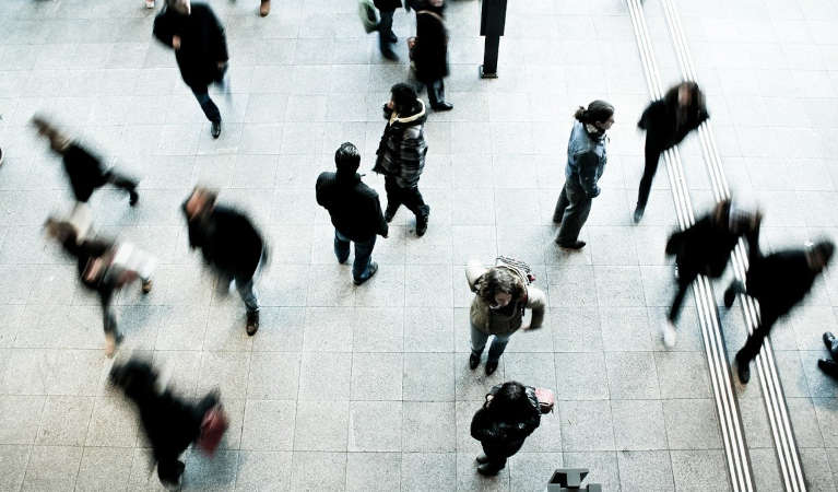 Pedestrians walking in a square.