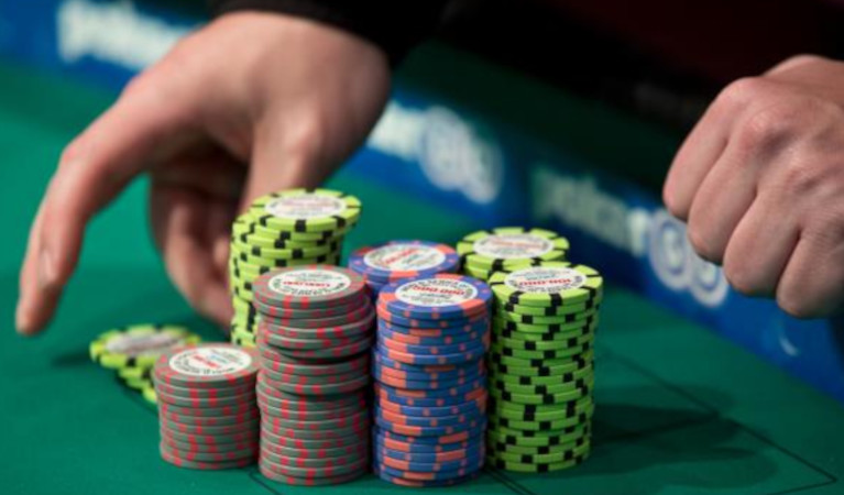 Poker-chips-and-a-croupier's-hands-at-a-wsop-tournament