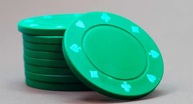 Green poker chips waiting to be played.